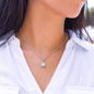 Woman wearing the Eternal Hope pendant necklace with a white collared shirt
