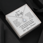 To My Wife message card necklace in a white gift box on black fabric