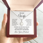 Hand holding the mahogany gift box with the To My Wife necklace and message card