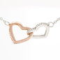 Rose gold and silver Interlocking Hearts pendant necklace close-up