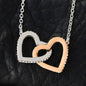 Interlocking Hearts pendant necklace on black leather showing cubic zirconia detail
