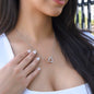 Woman wearing the Interlocking Hearts necklace, a romantic gift for wife